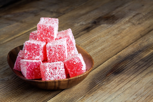 Red Turkish Delight with coconut in a wooden bowl  - Photo, Image