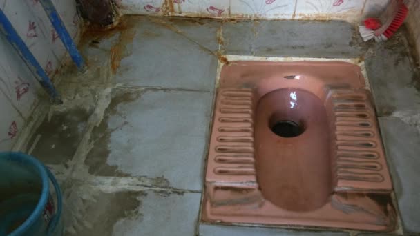 A close view of a dirty Indian-style toilet or squat toilets at an Indian local village - Metraje, vídeo