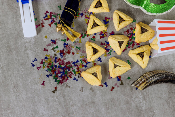 Jewish holidays religious Purim festival with hamantaschen cookies shofar noisemaker tallit carnival masks as symbols of celebration - Fotoğraf, Görsel