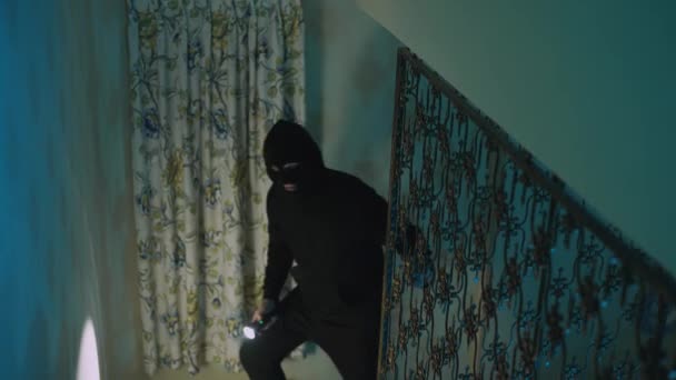 Thief in a balaclava at night in the house. - Záběry, video
