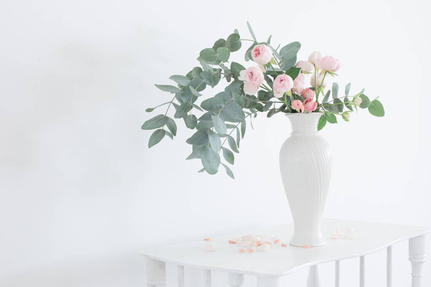 bouquet of pink roses in ceramic white vase  on white vintage wooden shelf - Photo, Image