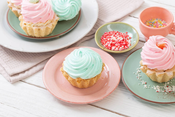 cupcakes on plates on white wooden background - Valokuva, kuva