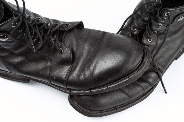A pair of worn men's leather boots isolated on a white background - Φωτογραφία, εικόνα