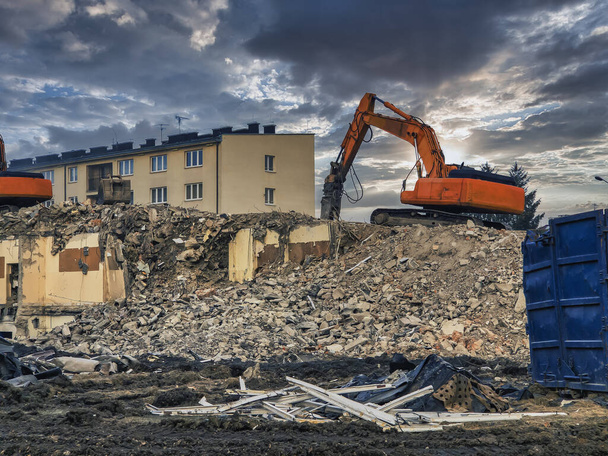Dismantling the Past. Powerful Yellow Excavator Razes Armored Concrete Structures to the Ground - Valokuva, kuva
