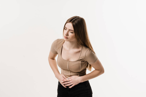 Sick attractive girl hold abdomen because it hurts. Stomach pain. Pancreatitis disease of pancreas becomes inflamed - Fotoğraf, Görsel