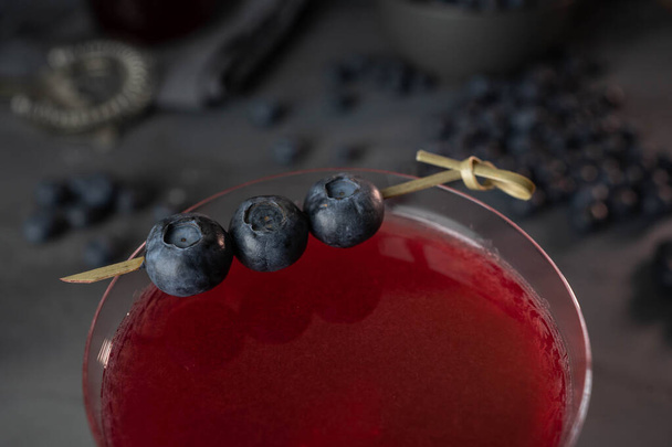 Fresh berries cocktail with bluenerries. Summer cold drink and cocktail on dark background. - Foto, afbeelding