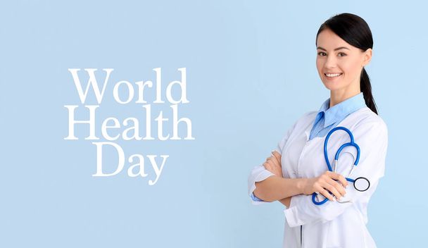 Female cardiologist on light blue background. World Health Day - Foto, immagini