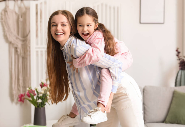 Cute little girl with her mom at home on Mother's Day - Zdjęcie, obraz