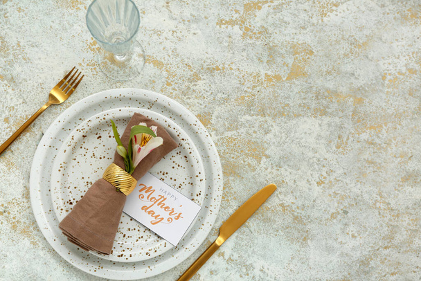 Stylish table setting with golden cutlery for Mother's Day celebration on light background - Photo, Image