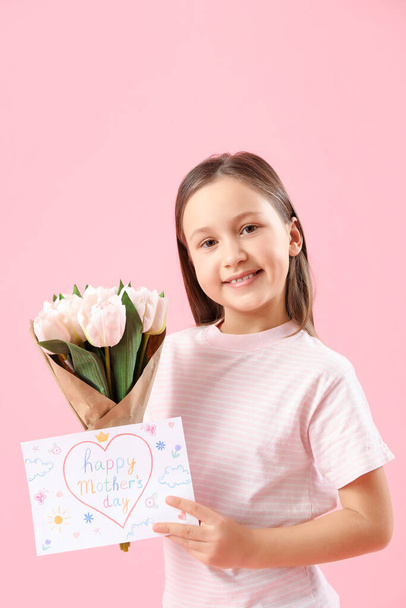 Little girl with greeting card for Mother's Day and tulips on pink background - Фото, изображение