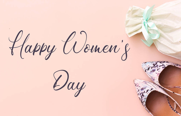 Kansainvälinen naistenpäivä, 8. maaliskuuta, vaaleanpunainen korkokengät ja muovipussi vaaleanpunainen tausta - Valokuva, kuva