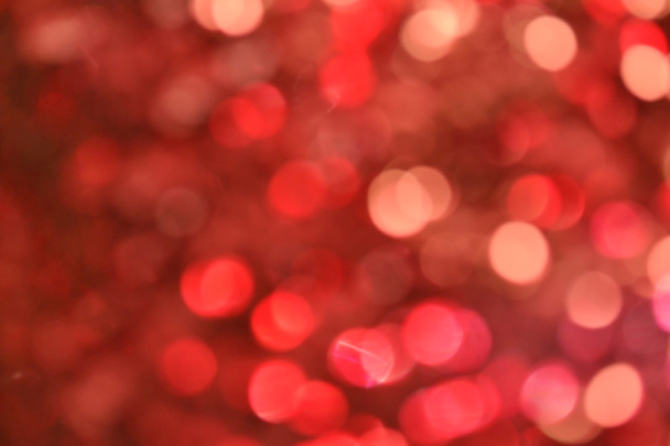 Fundo vermelho embaçado brilhante e abstrato com brilho cintilante
 - Foto, Imagem