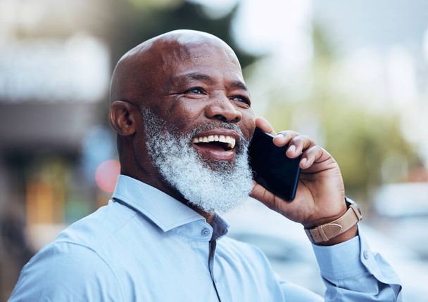 Business phone call, black man and laughing in city for conversation, mobile networking or hello. Happy mature manager, outdoor communication and talking on smartphone for contact, good news and joke. - Photo, Image