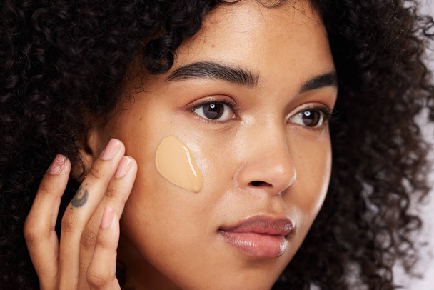 Black woman, beauty and face, foundation and makeup, cosmetics product zoom and cream on studio background. Hand, skin and wellness with dermatology, cosmetic care and sunscreen with African female. - Foto, Bild