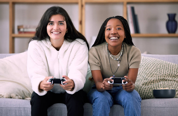 Friends, women on sofa and video games for quality time, relax or happiness on break, competitive or multiplayer app. Female gamers, ladies or controllers for esports, fun or entertainment with smile. - Φωτογραφία, εικόνα