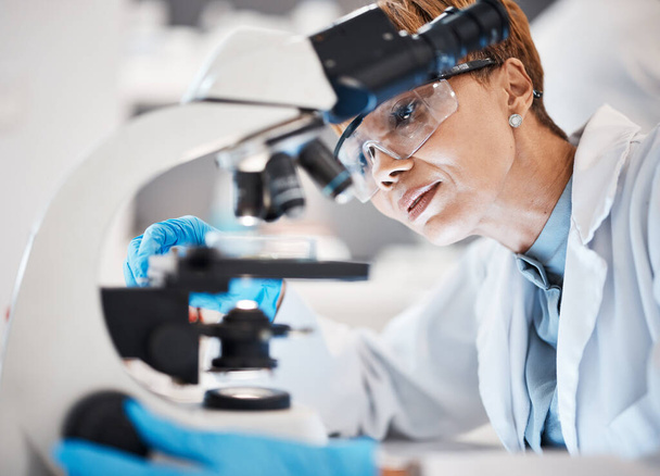 Medical science, woman and microscope in a laboratory for research, analytics and to study particle. Scientist person with glasses for dna or bacteria in lab for innovation, future and biotechnology. - Foto, Imagen