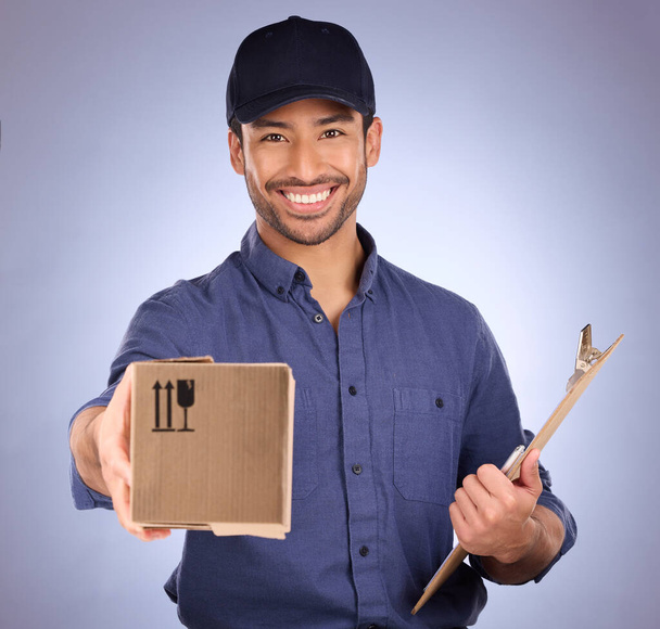 Portrait of delivery man giving box isolated on studio background for courier services, clipboard and smile. Asian worker, business or logistics person package in Korea distribution and product offer. - Fotografie, Obrázek