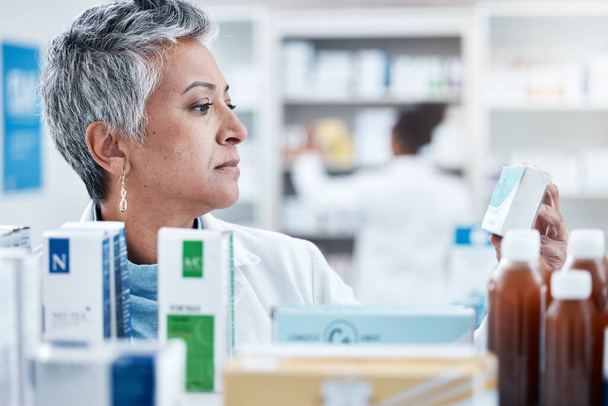 Senior woman, pharmacist and check with box, medicine or pills by shelf in store for healthcare services. Elderly pharma expert, retail stock and medical product for mockup space, health and wellness. - 写真・画像