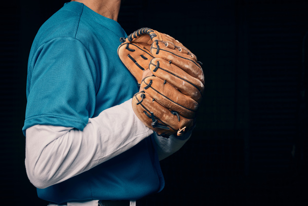 Baseball pitcher, hand and glove in studio for sport, training and throwing by black background. Man, cropped and hands for exercise, strikeout or athlete with sports, game or competition for workout. - Fotografie, Obrázek