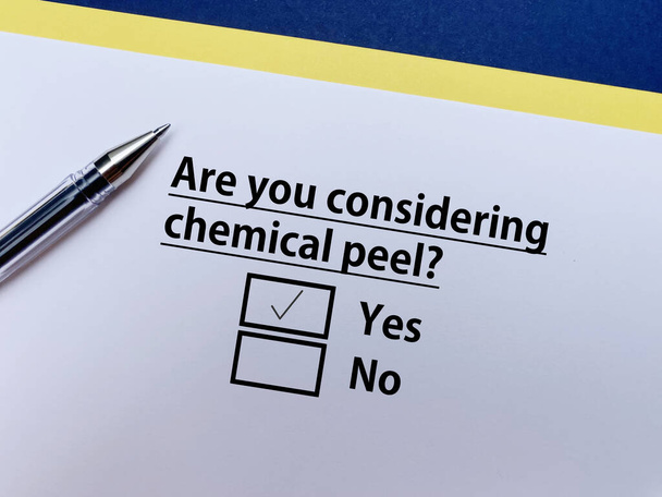 A person is answering question about cosmetic surgery. She is considering chemical peel. - Φωτογραφία, εικόνα