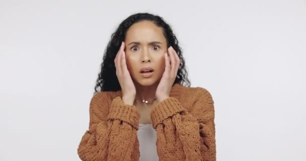 Shock, fear and expression with a black woman in studio on a gray background looking worried or scared. Anxiety, panic and a shocked young female feeling overwhelmed on confused while standing alone. - Filmati, video