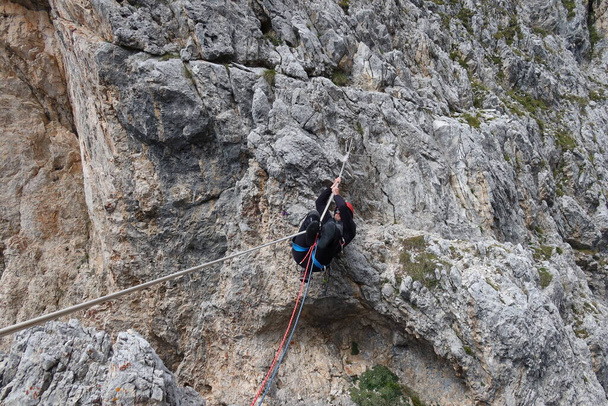 man hanging on rope dolomites panoramic views climbing outdoor europe. High quality photo - 写真・画像