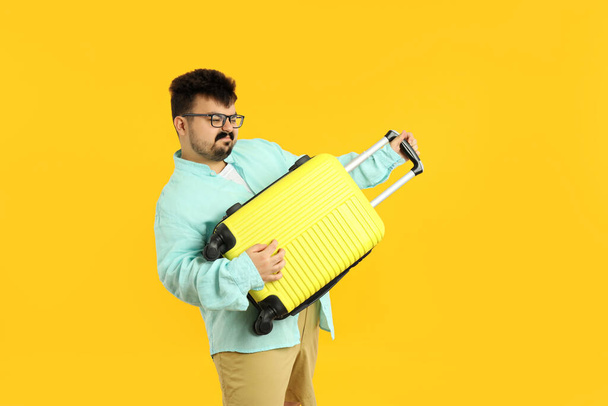 Concept of travel, young fat man on yellow background - Foto, Imagem