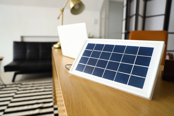 Portable solar panel on table in office, closeup - Foto, afbeelding