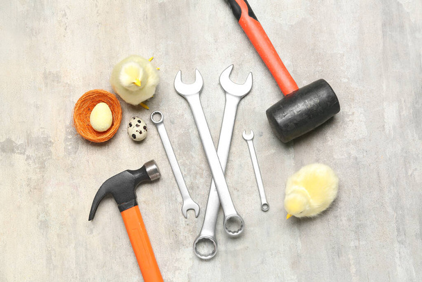 Handyman's tools with chickens and Easter eggs on grunge background - Fotó, kép