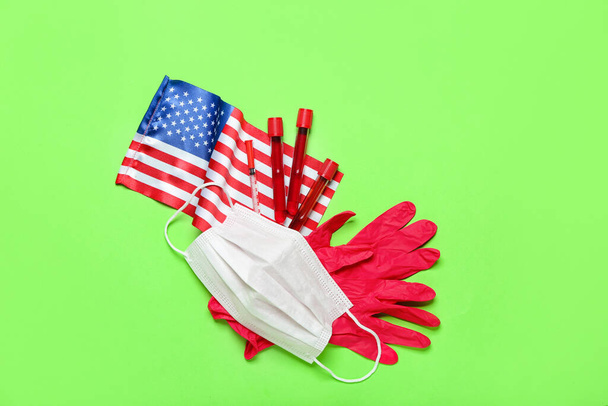 Medical mask, test tubes, gloves and USA flag on green background - Foto, Imagem