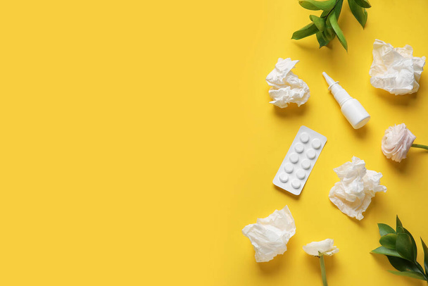 Nasal drops with pills, flowers and tissues on yellow background. Seasonal allergy concept - Foto, Imagem
