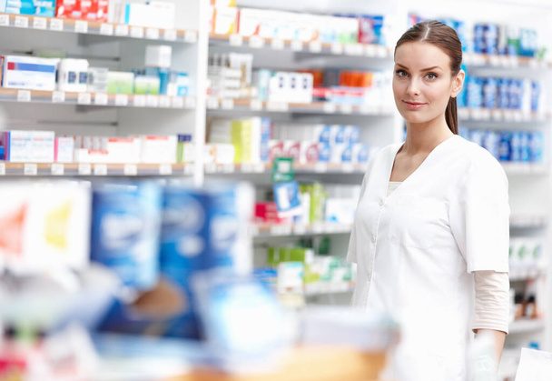 Smiling pharmacist at store. Portrait of beautiful pharmacist smiling at medical store - Φωτογραφία, εικόνα