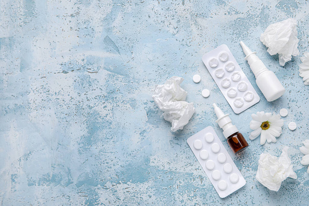 Nasal drops with pills, flowers and tissues on grunge background. Seasonal allergy concept - Photo, image