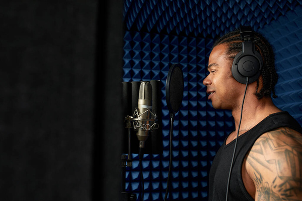 Young african american blogger recording new podcast, blogging, modern methods of personal brand development, boging as a business, modern artists. - 写真・画像