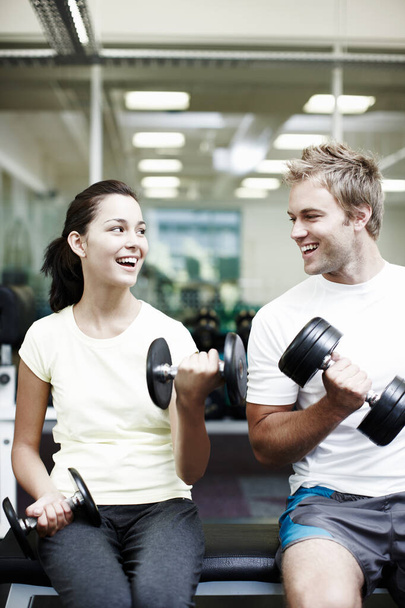 Working out together. two people working out using dumbbells in the gym - 写真・画像