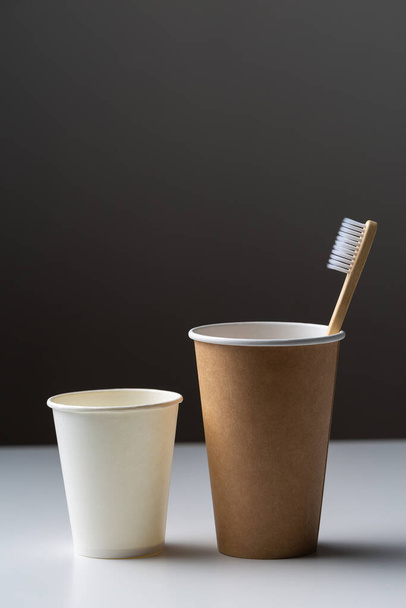 Toothbrush in a cardboard ecological cardboard cup, hygiene health care. - Foto, imagen