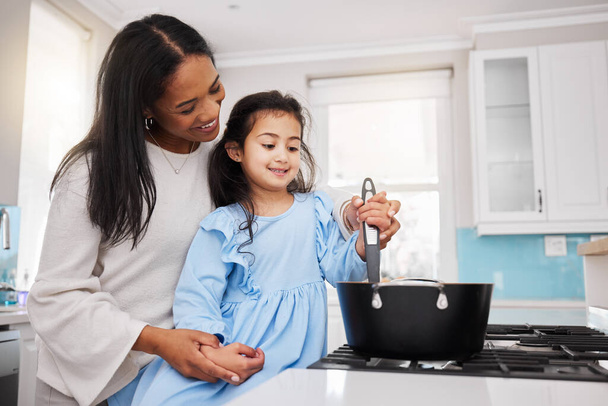 Cooking, food and happy with mother and daughter in kitchen for learning, bonding and meal preparation. Smile, health and nutrition with woman and girl in family home for teaching, diet and culinary. - Foto, imagen