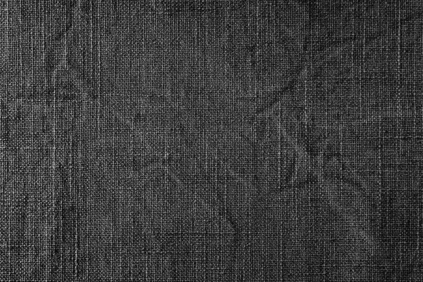Natural black linen fabric texture background. Flax cloth surface, tablecloth, upholstery, curtains textile. Top view, close up - Фото, изображение