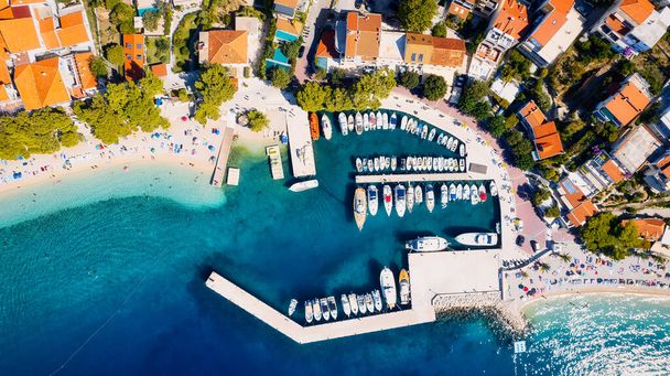 Chorvatský přístav je pohled shora. Tento dechberoucí letecký pohled zachycuje barevnou krajinu plnou plachetnic, motorových člunů a luxusních jachet odpočívajících v průzračně modré zátoce. Přidat tento obrázek cesty do vaší sbírky  - Fotografie, Obrázek
