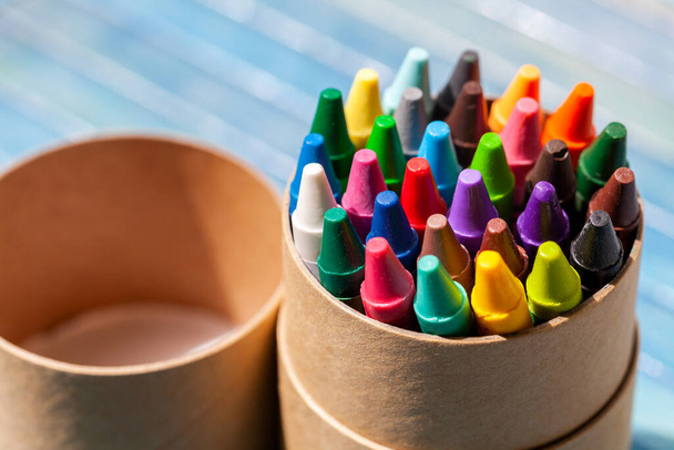 A simple pack, set of colorful wax crayons, multi colored crayon tube container object closeup, detail. Creativity, creative arts and crafts activities abstract concept, symbol, nobody, no people - Fotoğraf, Görsel
