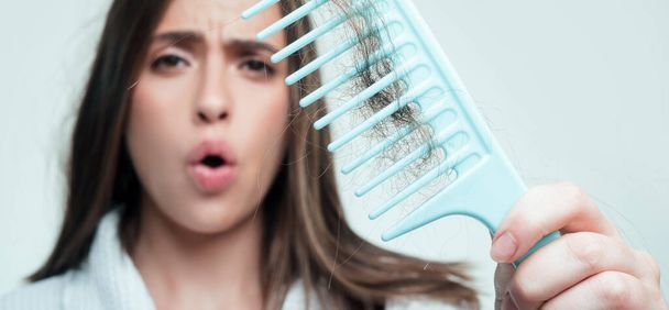 Hair loss woman with a comb and problem hair. Hairloss stressed woman and bald problems - Valokuva, kuva