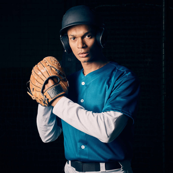 Baseball player, black man and studio portrait with focus, vision and balance for sport, fitness and motivation. Sports, exercise and training with goals, contest or competition by dark background. - 写真・画像