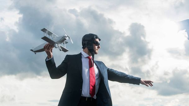 businessman in suit and pilot hat launch plane toy. ability. - Fotografie, Obrázek
