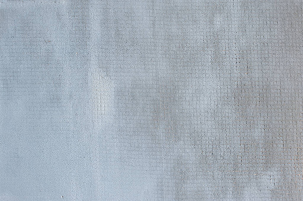 Close-up of a plastic PVC gypsum mesh for reinforcing the first layer of gypsum plaster on a wall. The concept of building and repairing a house. Background. - Φωτογραφία, εικόνα