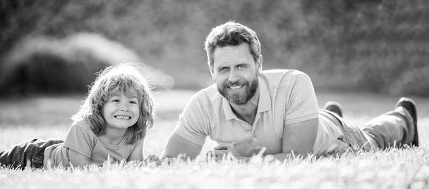 parenting and fatherhood. fathers day. smiling father and son having fun in park. family value. childhood and parenthood. parent relax with little child boy on grass. glad dad with kid on summer day. - Photo, Image