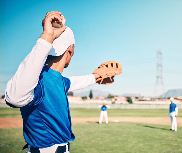 Sports, pitcher and throwing with man on field for fitness, workout or training for competition match. Cardio, exercise and strike with athlete playing in outdoor stadium for game, practice or action. - 写真・画像