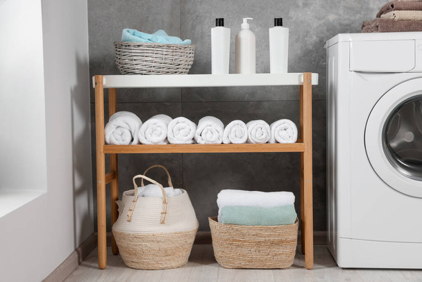 Many soft terry towels and washing machine in bathroom - Foto, Imagen