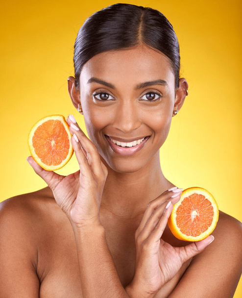 Skincare, smile and portrait of Indian woman with orange and facial detox with smile on yellow background. Health, wellness and face of model with organic luxurycleaning and grooming cosmetics. - Foto, immagini