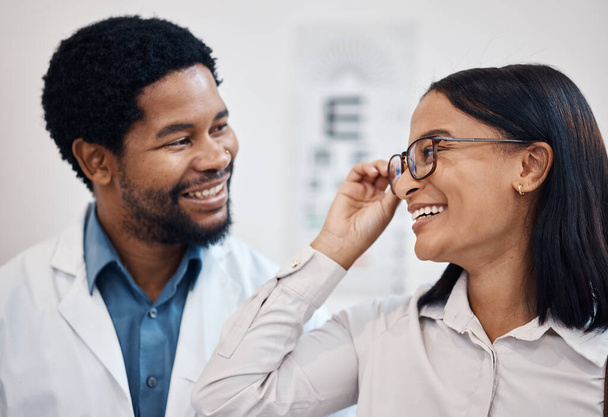 Optometrist consulting client with glasses, vision and customer services, support and advice on lens frame. Happy black woman with professional person for eyes healthcare, retail help and store test. - Photo, Image