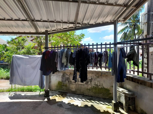 drying clothes in front of house in rainy season  - Foto, Imagem